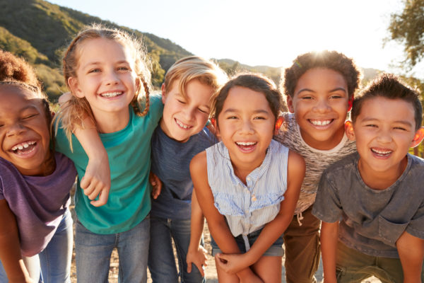 Portrait,Of,Multi-cultural,Children,Hanging,Out,With,Friends,In,Countryside